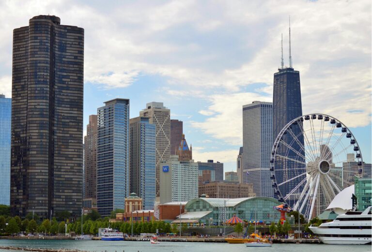 Chicago skyline featuring the iconic Ferris wheel on Navy Pier with skyscrapers like Hancock Tower.